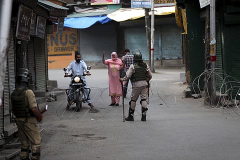 A Kashmir woman asks for permission to cross the road in Kashmir. (Photo| AP)