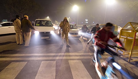 Policemen block the Parliament Street road towards the Connaught Place as people celebrate the New Year 2020 in New Delhi Tuesday Dec. 31 2019. (Photo | PTI)