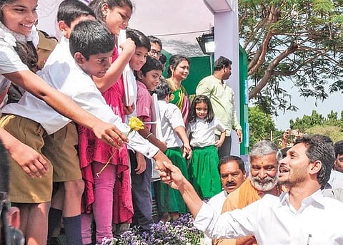 CM Jagan Mohan Reddy greets children at PVKN College in Chittoor on Thursday. (Photo| EPS/Madhav K)