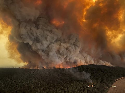 In this Monday, December 30, 2019, aerial file photo, wildfires rage under plumes of smoke in Bairnsdale, Australia. (File Photo | AP)