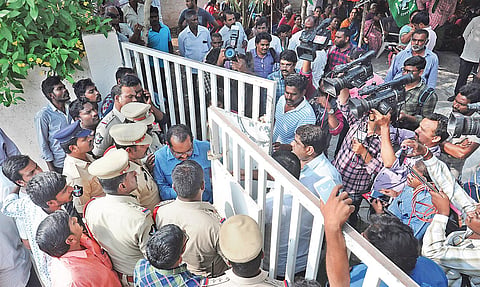 Police assist a special branch police officer who was detained by Mandadam villagers for entering a private property on Sunday| Prasant Madugula