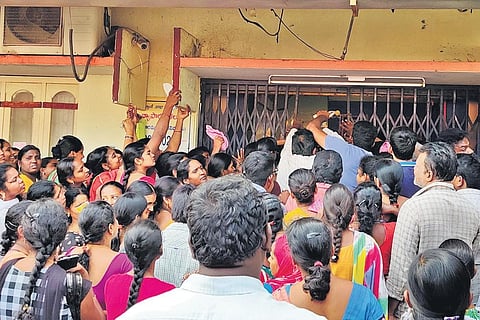 Women queue up at a bank in Krishna Lanka in Vijayawada on Monday, to withdraw financial aid under Amma Vodi scheme| Express