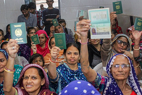 Hindu refugees who migrated from Sindh province of Pakistan display their passports as they support the Citizenship Amendment Act in Ahmadabad, Monday, Dec. 23, 2019. (File | PTI)
