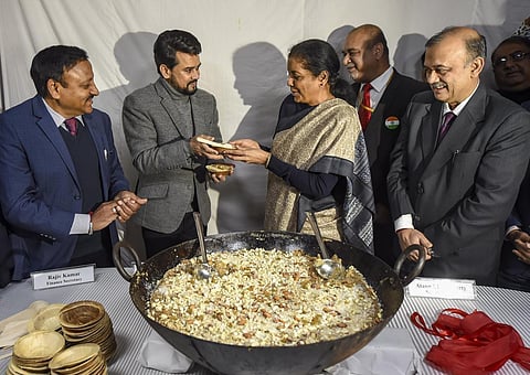Finance Minister Nirmala Sitharaman C and Minister of State for Finance Anurag Singh Thakur 2L Finance Secretary Rajiv Kumar L Economic Affairs Secretary Atanu Chakraborty R and others during 'Halwa' ceremony marking the commencement of Budget 2020. (Phot