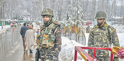 Security personnel stand guard during a public outreach programme on the outskirts of Srinagar on Tuesday | PTI