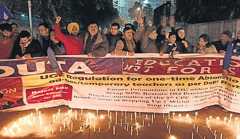 Teachers of Delhi University raise slogan during a protest demanding the absorption of ad-hoc staff, at ITO on Wednesday. (Photo | EPS)