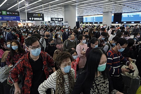 Passengers wear protective face masks at the departure hall of the high speed train station in Hong Kong. Fear about the effects of a new virus found in China is spreading faster through financial markets around the world than the sickness itself. (Photo