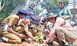 Student Police Cadets of Government High School, Chalai planting a sapling along with Kazue Fujiwara, professor of Yokohama National University, as part of the micro forest project at the school. (Photo| Vincent Pulickal, EPS)