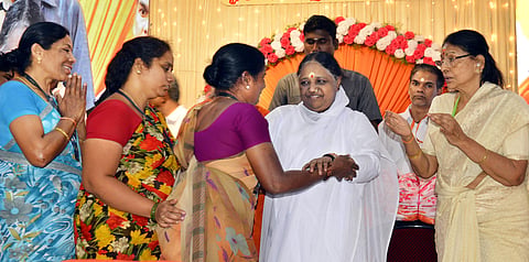 Amritanandamayi distributing sarees to underprivileged women at her math in Virugambakkam. (Photo | D Sampathkumar, EPS)
