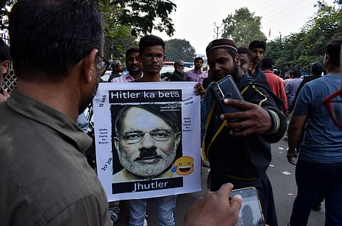 Protestors holding a placard of PM Modi depicting him as Hitler (Photos | Vinay Madapu, S Senbagapandiyan, EPS)