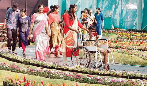 Sravan (sitting in the wheelchair), a student of SDPY KPMHS, Edavanakad, along with his sister at Cochin Flower Show in Ernakulathappan ground on Saturday Arun Angela