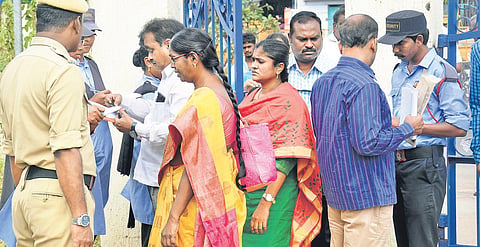 Security personnel note down details of electricity employees relieved by Telangana government at Vidyut Souda in Vijayawada on Monday.