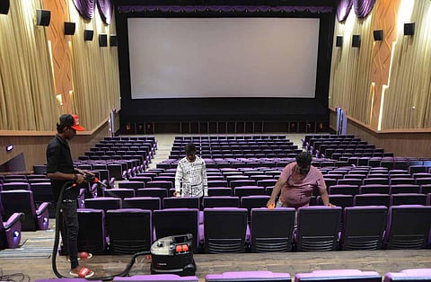 As cinemas are set to open from October 15, staff of a theatre in Tirunelveli sanitising the seats. (Photo | V Karthikalagu, EPS)