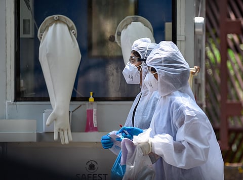 Medics walk past a swab testing cabin in a hospital in Mumbai. (File Photo | PTI)