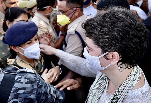 Congress leader Priyanka Gandhi Vadra speaks to police personnel as they are stopped by Uttar Pradesh Police at Yamuna Expressway on their way to Hathras. (Photo | ANI)