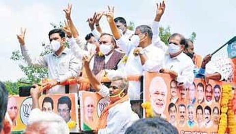 Panchayat Raj Minister K S Eshwarappa and BJP state unit vice-president B Y Vijayendra during a rally in Sira on Friday