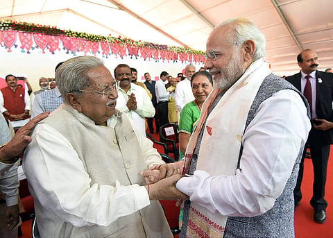 Prime Minister Narendra Modi greeting the former chief minister of Gujarat Keshubhai Patel at swearing-in ceremony. (File| PTI)