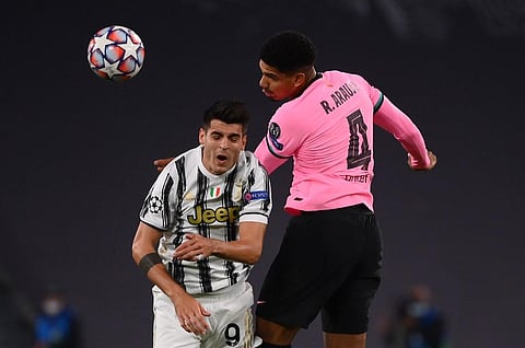 Barcelona's Uruguayan defender Ronald Federico Araujo da Silva fights for the ball with Juventus' Spanish forward Alvaro Morata. (Photo | AFP)
