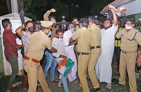 Police removing Youth Congress workers who sneaked into the high-security area and reached the gate of Cliff House, the official residence of CM Pinarayi, in Thiruvananthapuram on Friday. | Express