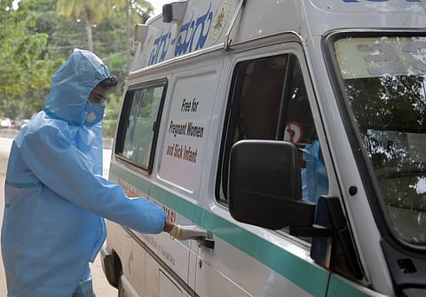 A healthcare worker gets ready to pick up patients in Bengaluru (Photo | Meghana Sastry, EPS)