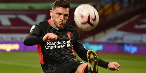 Liverpool's Andrew Robertson clears the ball during the EPLÂ match against Aston Villa at the Villa Park stadium in Birmingham. (Photo | AP)