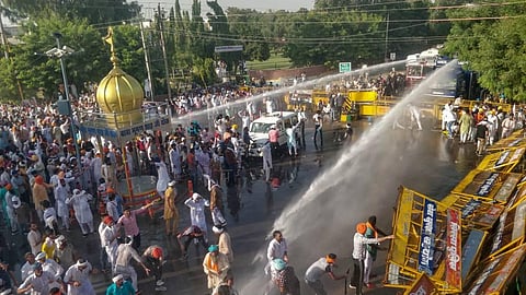 Police personnel use water cannons to disperse farmers during a massive protest against the new farm bills in Sirsa district Tuesday Oct. 6 2020. (Photo | PTI)