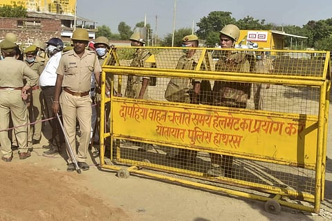 File photo of cops barricading a road leading to Hathras victim's village (File Photo | PTI)