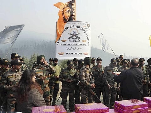 ashtriya Rifles personnel celebrate Diwali with sweets sent by classmates of the late Colonel Santosh Mahadik who was killed after getting injured in a gunbattle with terrorists. (Photo | Twitter)