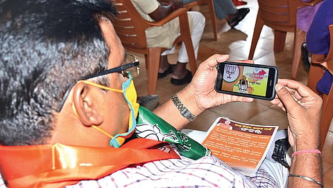 A BJP leader attending Home Minister Amit Shah’s virtual rally at a BJP party office. (Photo | EPS)