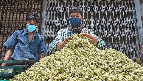 With the decreased demand for jasmine flowers, a street vendor awaits customers at the Big Bazaar street in Tiruchy on Friday. (photo| MK Ashok Kumar, EPS)