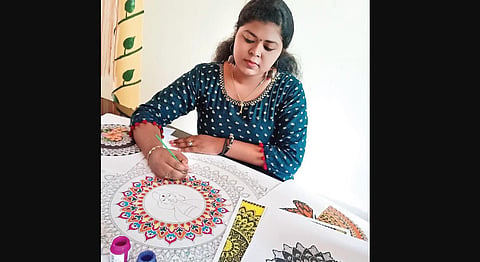Athira Sasi working on a painting | Express