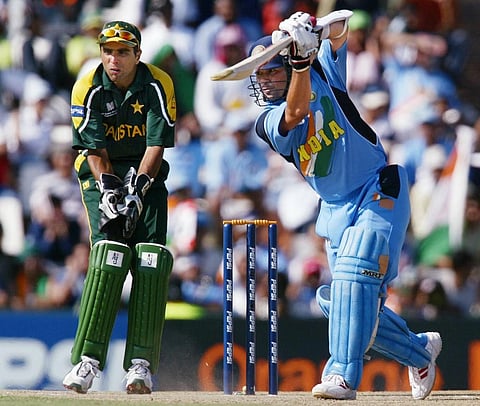 Sachin Tendulkar (R) drives the ball to towards the boundary during his innings of 98 runs. (File photo | AFP)