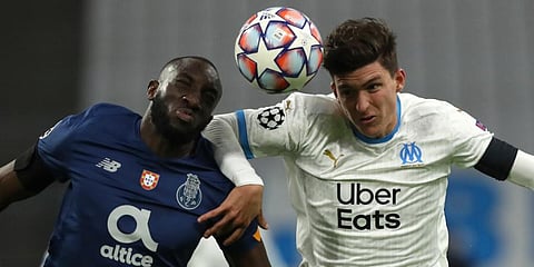FC Porto's Moussa Marega (L) and Olympique Marseille's Leonardo Balerdi challenge a ball during the Champions League group C soccer match at the Velodrome stadium. (Photo | AP)
