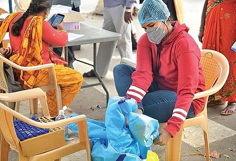 A technician at a Covid sample collection booth in Bengaluru takes off her PPE suit after her shift on Friday | Meghana Sastry
