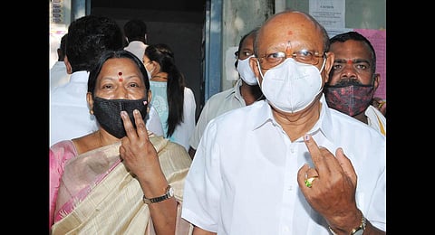 T B Jayachandra, Congress candidate for Sira, and his wife Nirmala after casting their votes, on Tuesday | Express