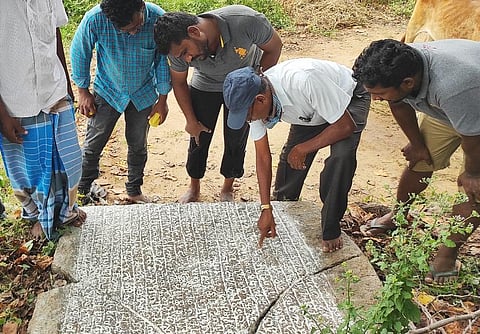 Archaeological enthusiasts looking into the stone inscription found at a village in Tirupathur district (Photo | EPS)