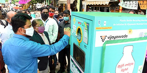Krishna collector MD Imtiyaz and municipal commissioner Prasanna Venkatesh inaugurating plastic bottle recycling machine at IGMC stadium in Vijayawada on Thursday. (Photo | EPS)