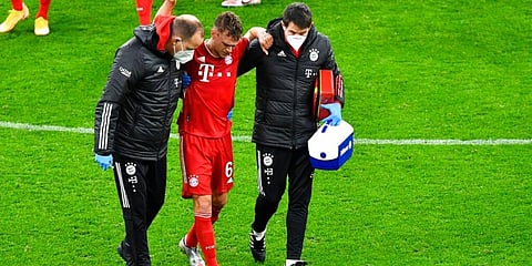 Bayern's Joshua Kimmich walks off after receiving medical treatment during German Bundesliga match against Borussia Dortmund. (Photo AP)