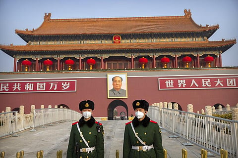 Paramilitary police wear face masks as they stand guard at Tiananmen Gate adjacent to Tiananmen Square in Beijing. (Photo | AP)