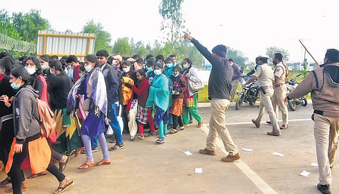 Police personnel disperse a crowd that had gathered in front of Wistron’s iPhone facility near Kolar on Saturday | EXPRESS