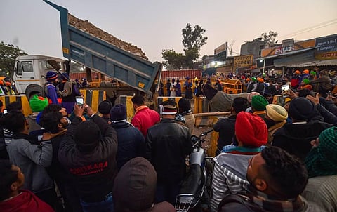 Police dump soil near Singhu border in an attempt to stop farmers' from entering the national capital. (Photo | PTI)