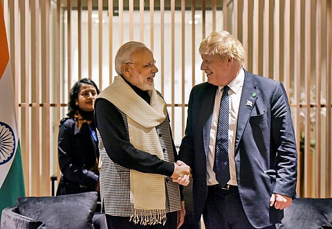 Prime Minister Narendra Modi shakes hands with British Prime Minister Boris Johnson in London. (Photo| PTI)