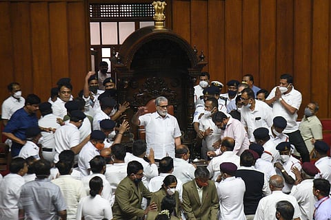 Politicians crowd around Chairman PC Shetty during the Legislative Council session in Bengaluru on Tuesday. (Photo | Nagaraja Gadekal, EPS)