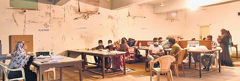 With not many turning up to cast their votes, polling staff sit idly at an election booth in the Old City of Hyderabad on Tuesday.| Vinay Madapu