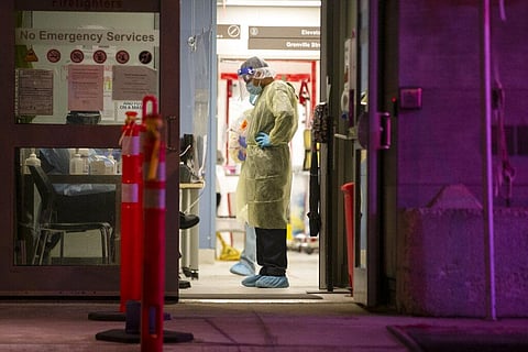 A Healthcare worker pauses during a lull in visitors at a COVID-19 testing center in Toronto, Sunday, Dec. 20, 2020. (Photo | AP)