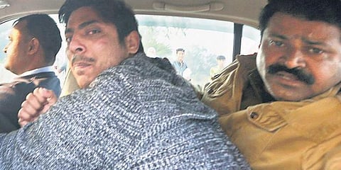 File photo of police taking away Kapil Gujjar after he opened fire at Shaheen Bagh area of Delhi (Photo | Shekhar Yadav)
