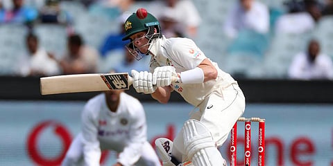 Australia's Steve Smith attempts to avoid a bouncer while batting during play on day three of the second Test against India at the Melbourne Cricket Ground. (Photo | AP)