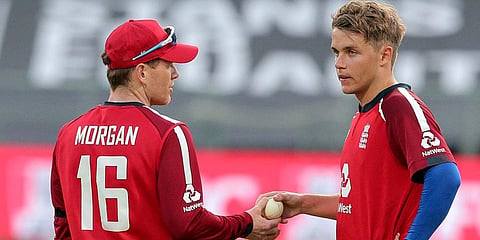 England's Eoin Morgan and Sam Curran discuss tactics during a T20 match against South Africa in Cape Town. (Photo | AP)