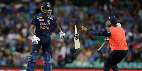 India's Hardik Pandya tosses his bat towards his teammate to exchange it during the second T20 international cricket match against Australia. (Photo | AP)