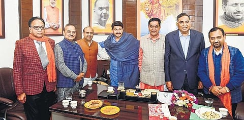 Newly-elected BJP MLAs meet Delhi BJP chief Manoj Tiwari (C) at his office. (Photo| PTI)